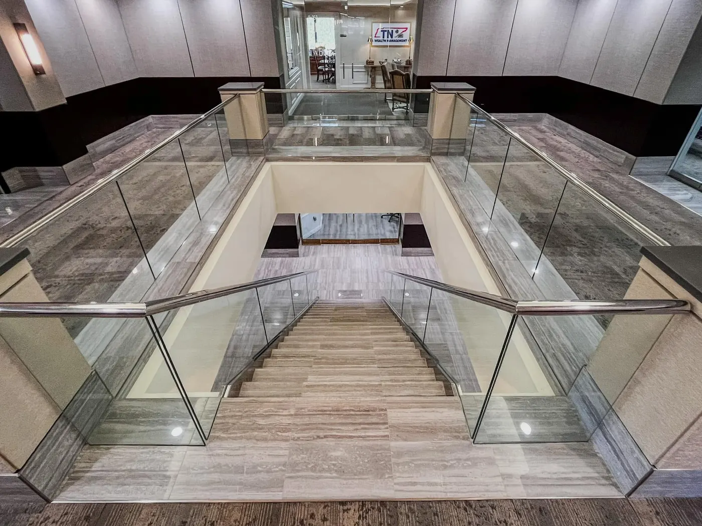 Double-staircase atrium with stone-look flooring