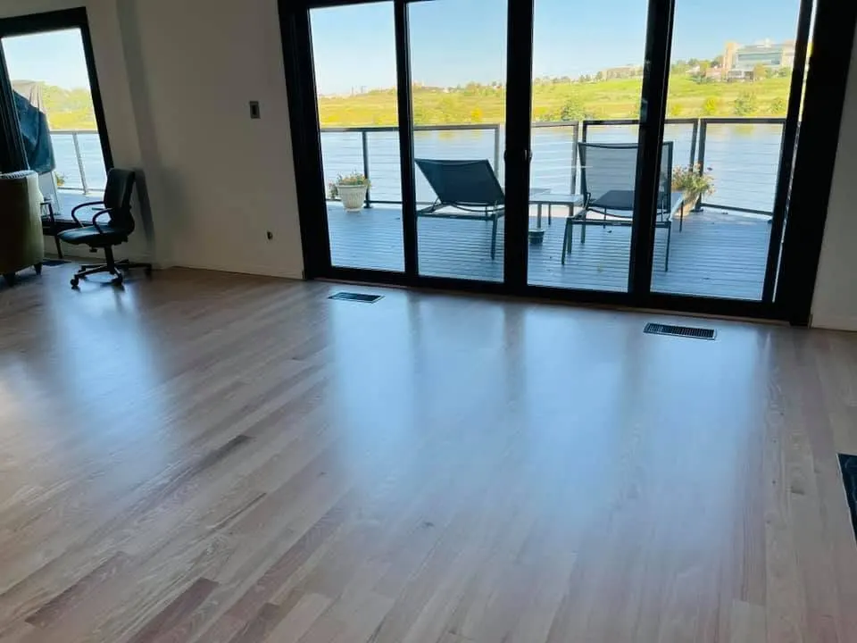 Light wide-plank flooring in a lakefront room